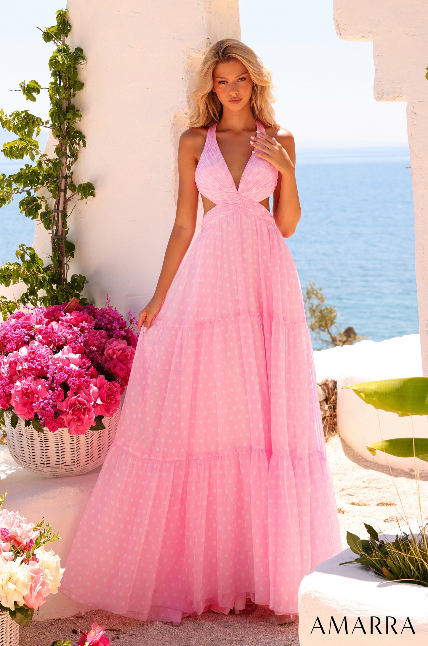 Amarra style 89730 long light pink polka dot dress with subtle white dots, plunging halter neckline, cutout sides and three-tiered a-line skirt, front view