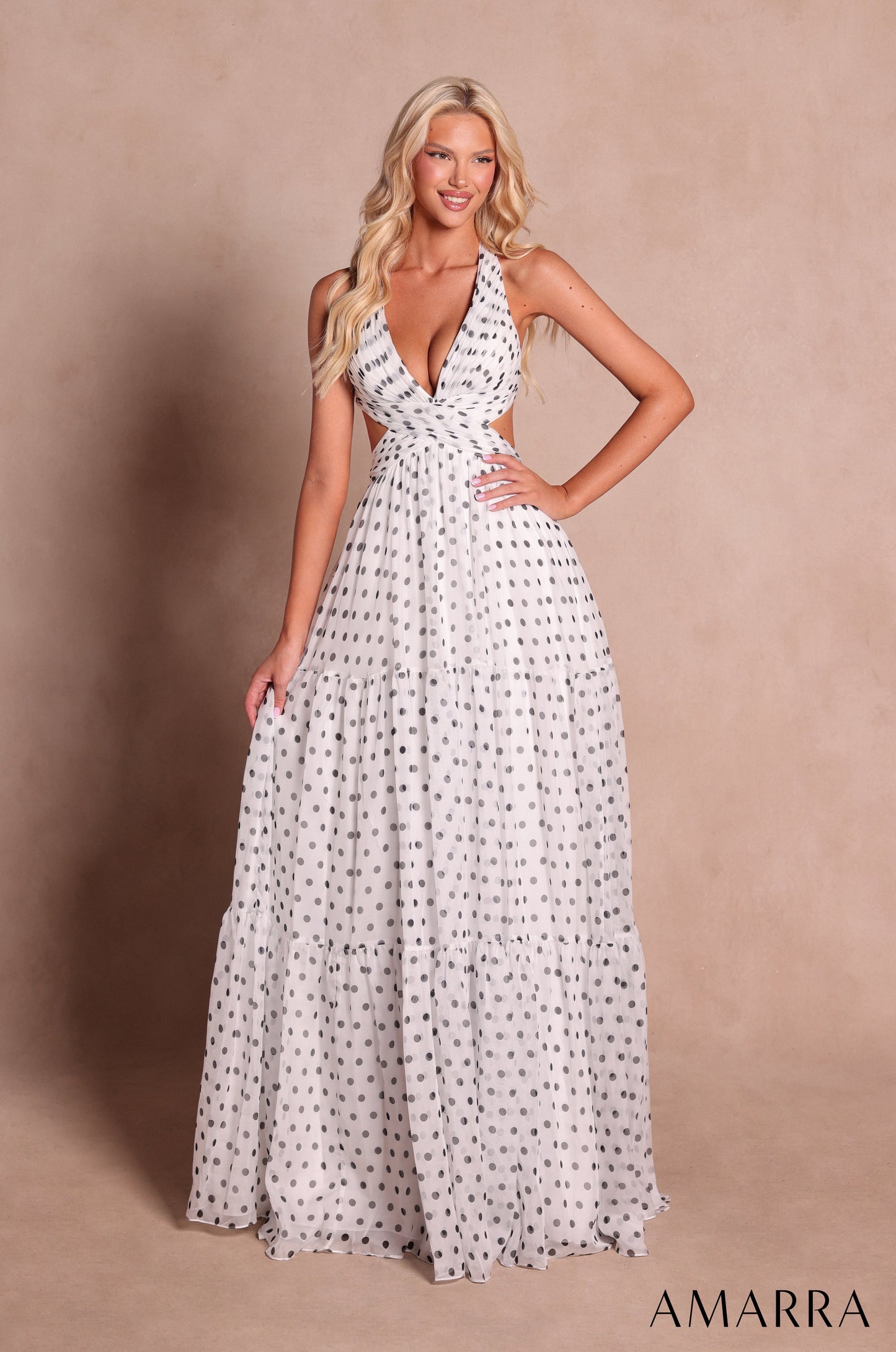 Amarra style 89730 long white polka dot dress with black dots, plunging halter neckline, cutout sides and three-tiered a-line skirt, front view